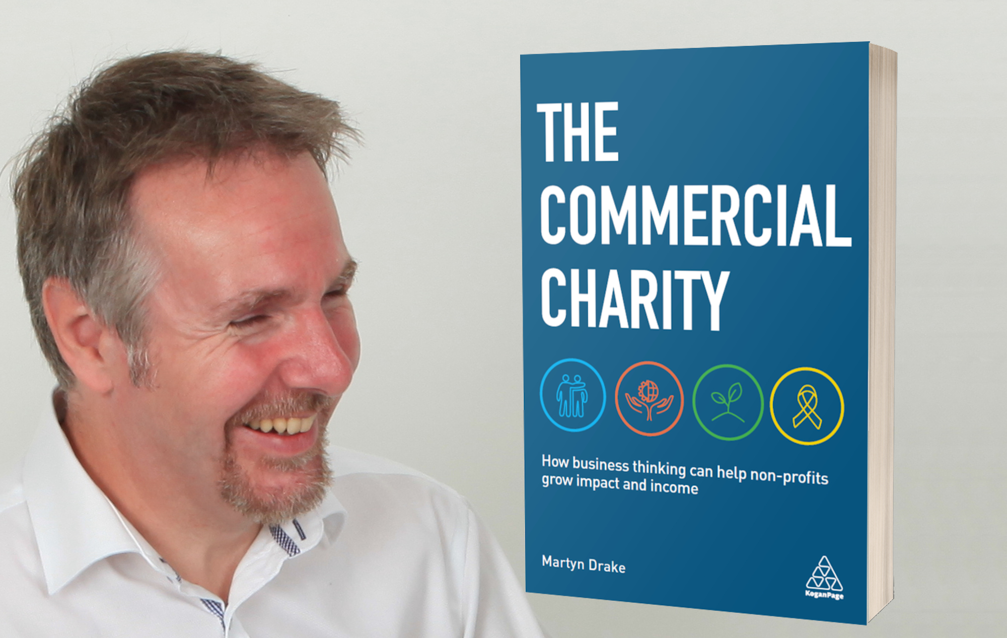 Martyn Drake smiling with his book "The Commercial Charity" displayed beside him, featuring the subtitle "How business thinking can help non-profits grow impact and income" on a blue cover.