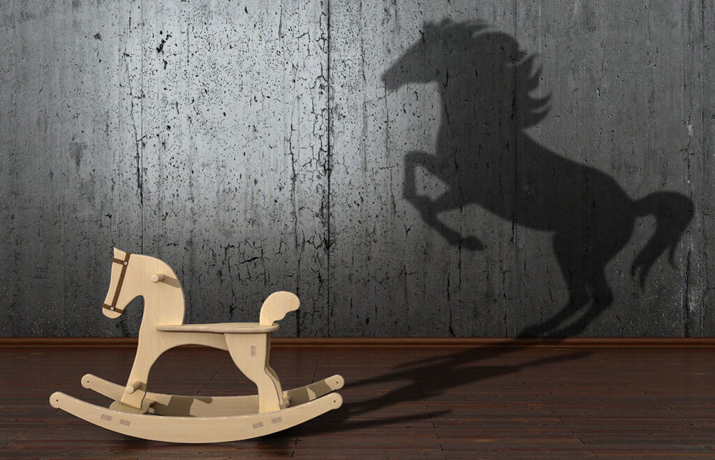 Scaling impact - image of a rocking horse casting a shadow of a much bigger real horse