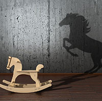 Scaling impact - image of a rocking horse casting a shadow of a much bigger real horse