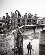 Photo of a diverse crowd of people crossing a bridge to symbolise civil society bridging the divides