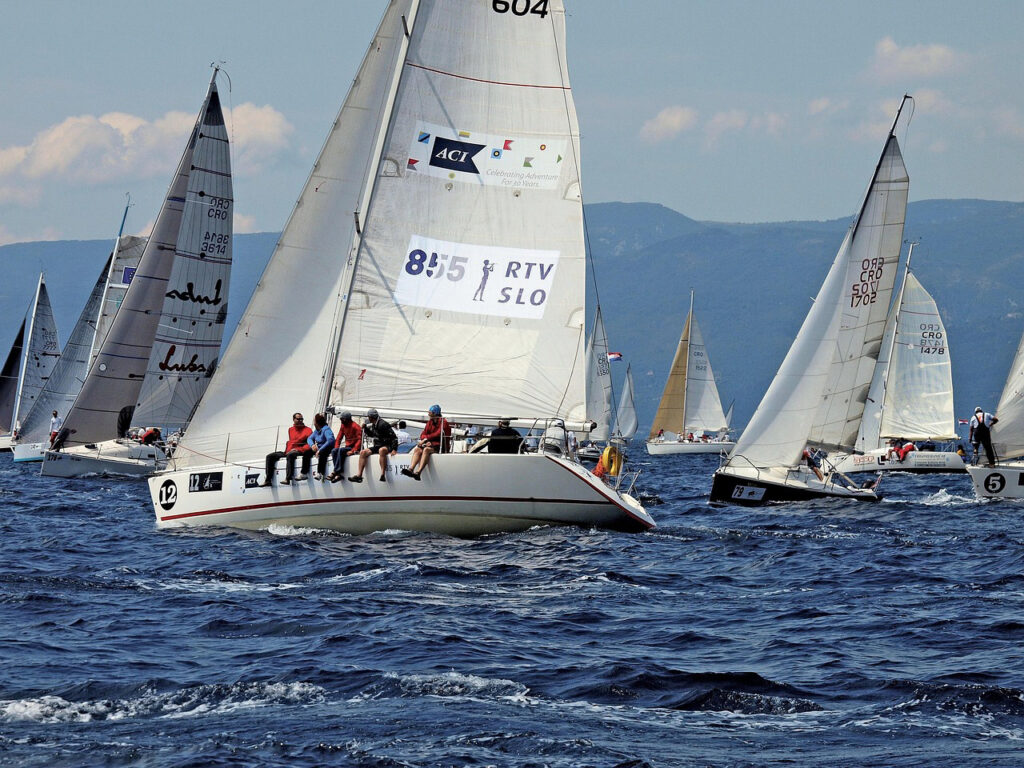 Opportunity from adversity image of a sailing race with the boat in the foreground tacking across the boats behind