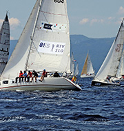Opportunity from adversity image of a sailing race with the boat in the foreground tacking across the boats behind