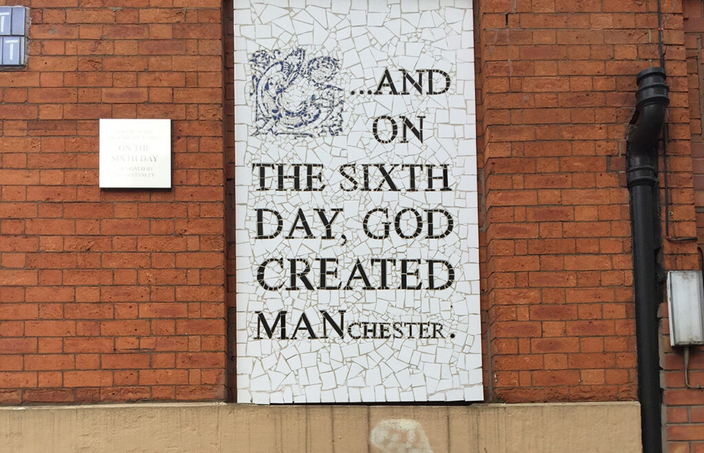 How things can change header image - a photo of a mosaic on an urban wall with the words, on the sixth day, God created Manchester