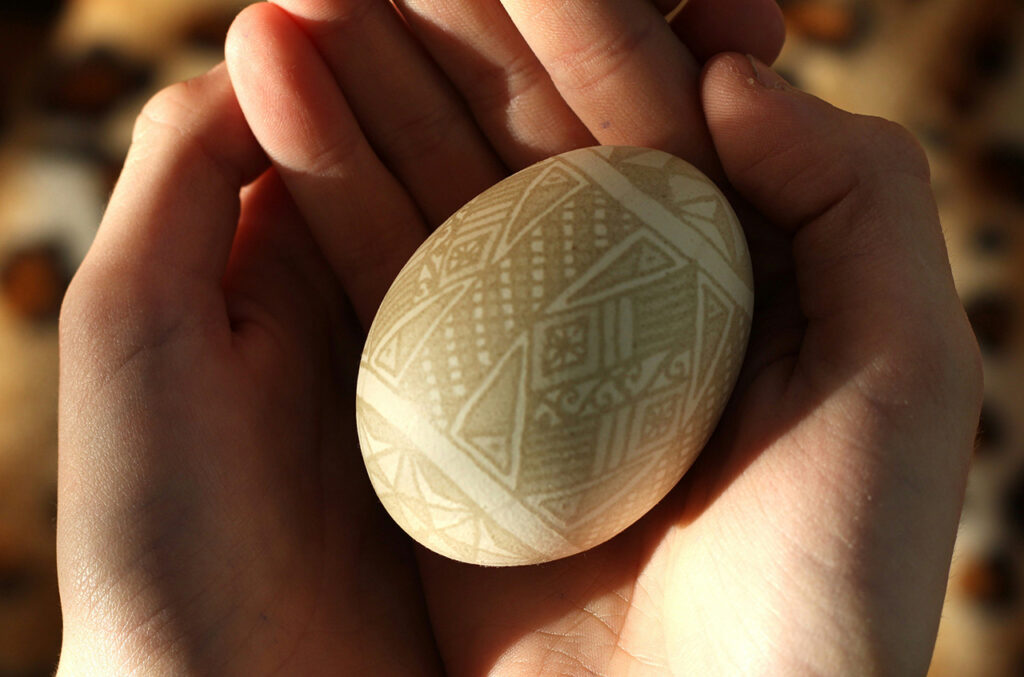 Image for the art of culture change showing cupped hands holding an elaborately decorated egg