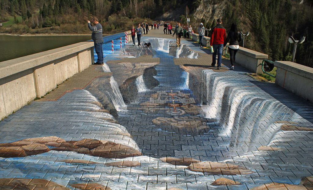 Photo of a bridge with chalk artwork covering the pavement making it look like the bridge is broken depending from what perspective it is viewed