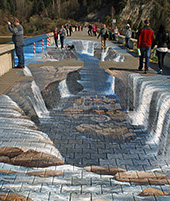 Photo of a bridge with chalk artwork covering the pavement making it look like the bridge is broken depending from what perspective it is viewed