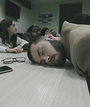 The team delusion - a photo of a meeting with one person falling asleep and others distracted