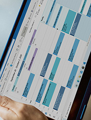 Personal impact image - a photo of someone holding an iPad showing a calendar full of commitments